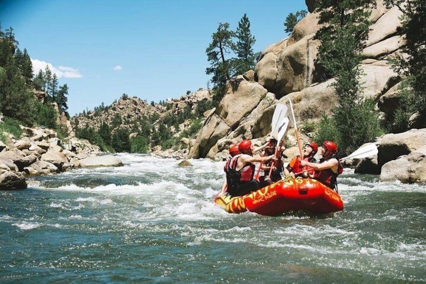 Paddlers high-fiving after Zoom Flume rapid in the world-class rafting of Browns Canyon!