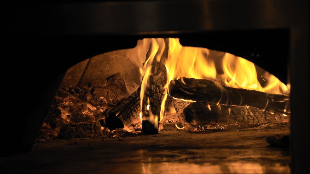 Show item 3 of 5. Burning stone hearth at a restaurant in Washington DC