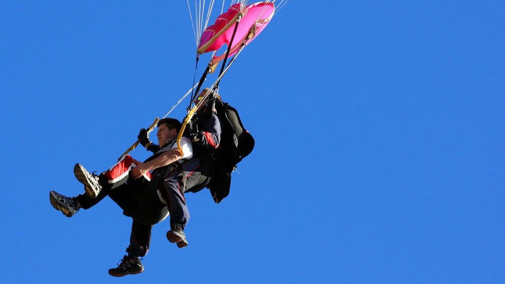 man sits in safety harness while sky diving in Torquay Victoria