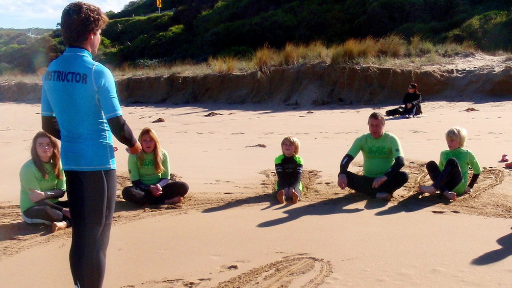 Show item 1 of 5. Instructor again over talking to students on the Great Ocean Road Surf Tour in Australia