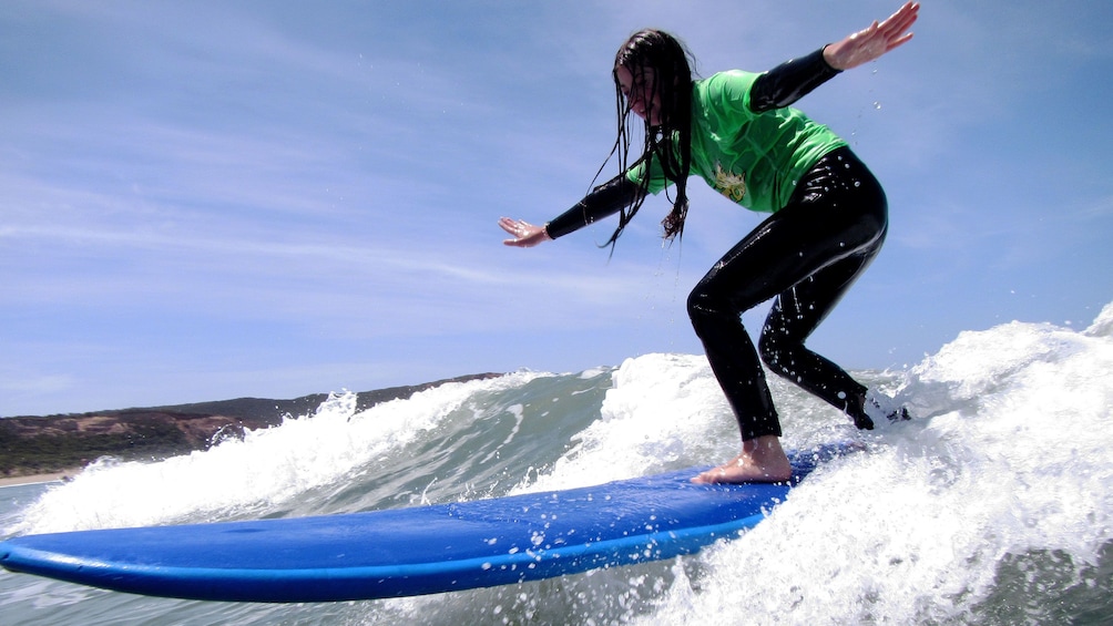 Show item 1 of 5. Close up of girl surfer student riding the wave on the Great Ocean Road Surf Lesson in Australia