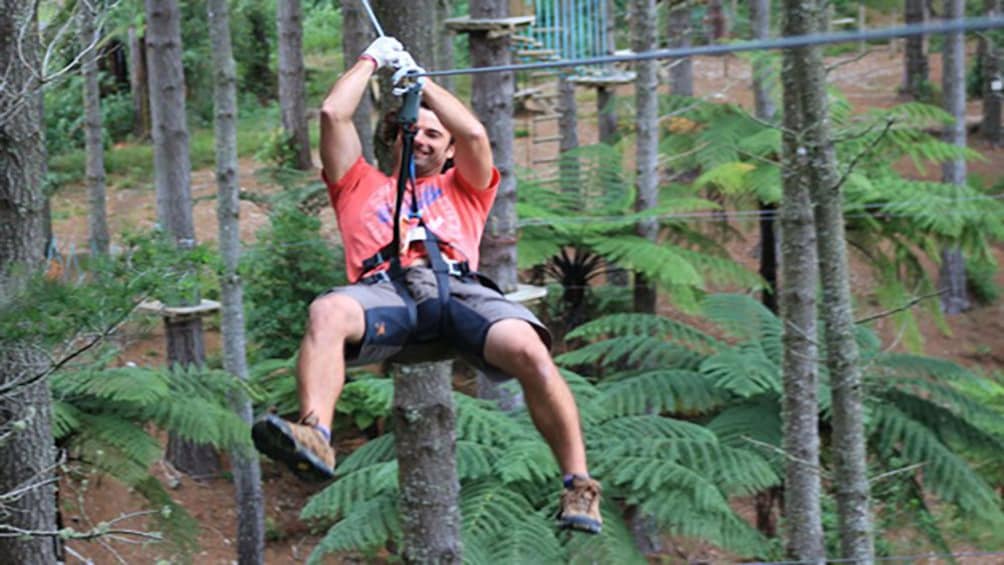Show item 1 of 5. man use zip line at zip course in Canterbury