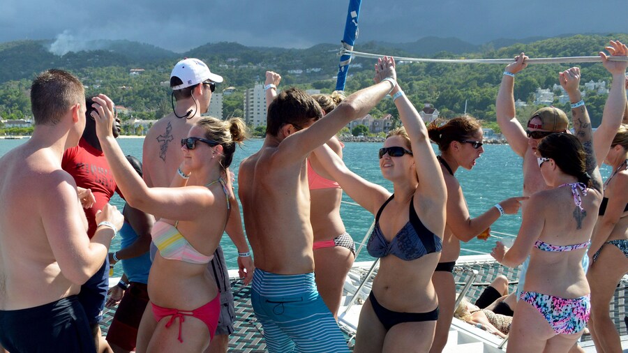 Group of people dancing on a sailboat off the coast of Nevis