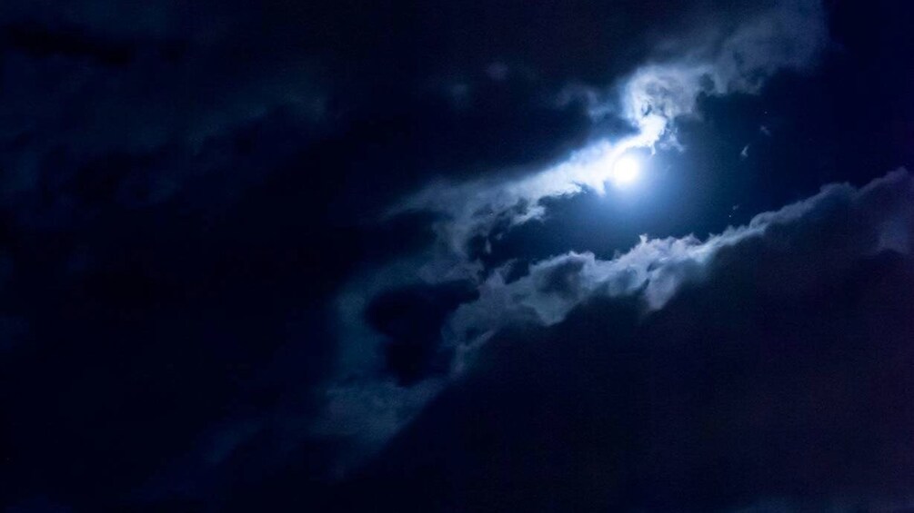 full moon behind clouds at night in Sydney