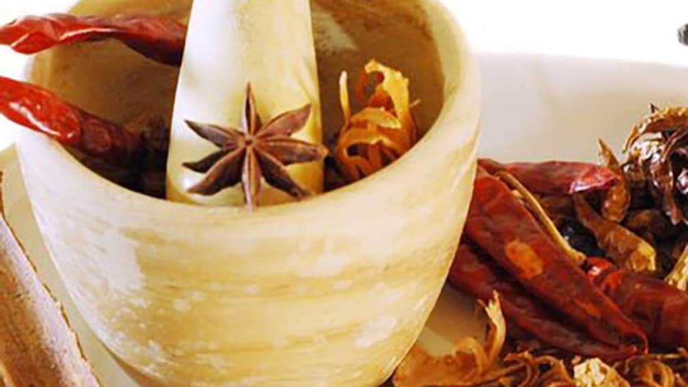 mortar and pestle with red chile peppers 