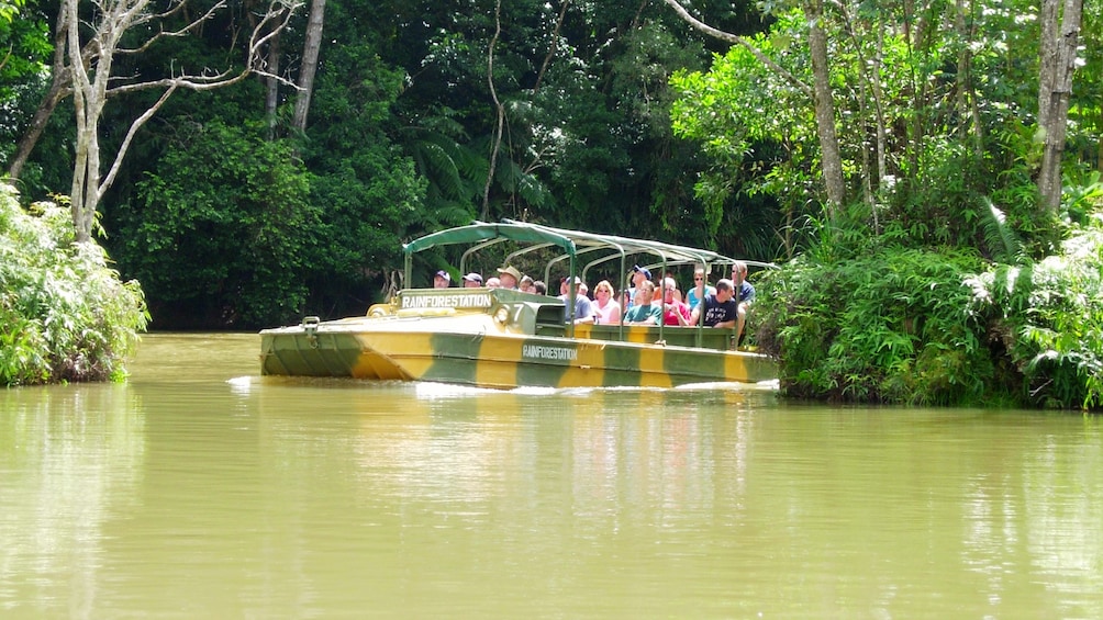 group of people enjoying ride on amphibious DUKW through river in Cairns