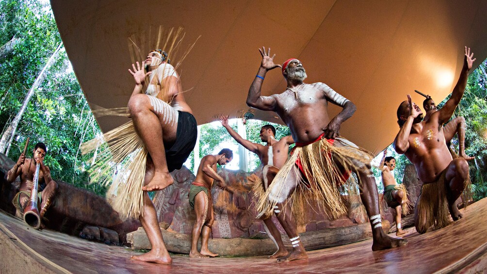 group of aboriginals perform a native dance in Cairns