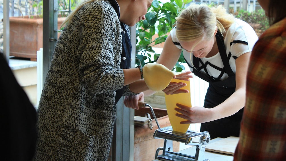 girls using pasta maker