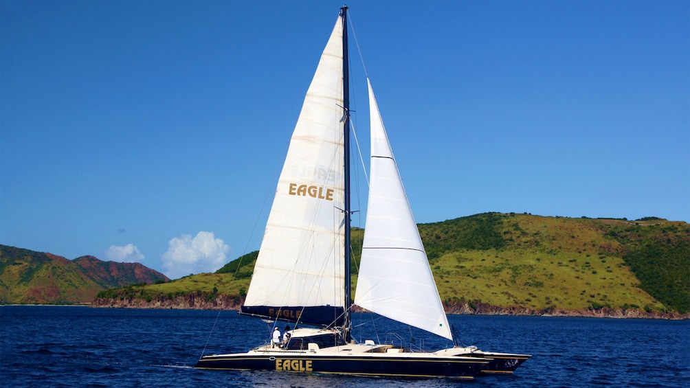 Catamaran sailboat on the water with St Kitts in the background