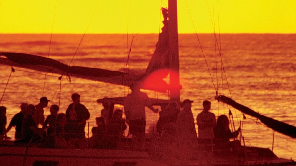 Silhouette of passengers on a catamaran at sunset in St Kitts