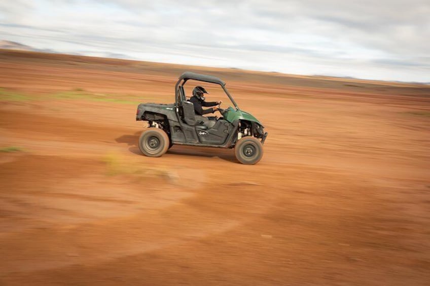 Traveler speeds through the Moroccan desert in a personal ATV.