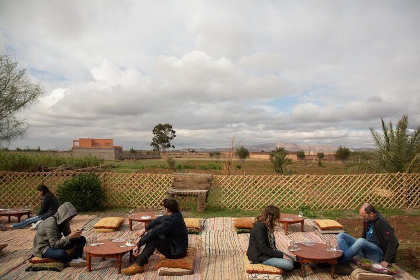 Travelers tuck into a traditional Moroccan tagine lunch after their camel ride.