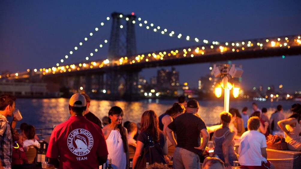 Tour group on a cruise boat at night in New York