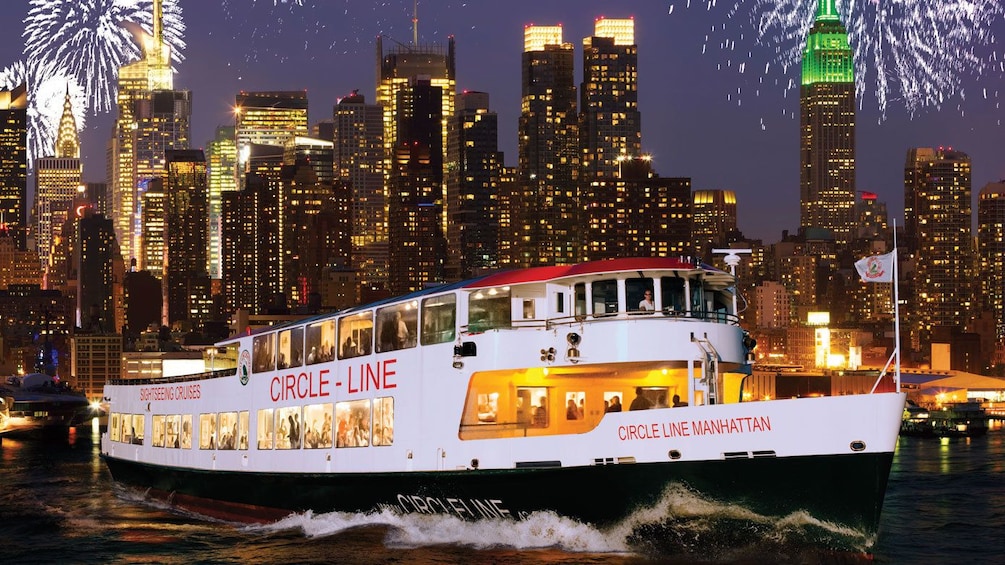 Cruise boat with fireworks and the city at night in New York