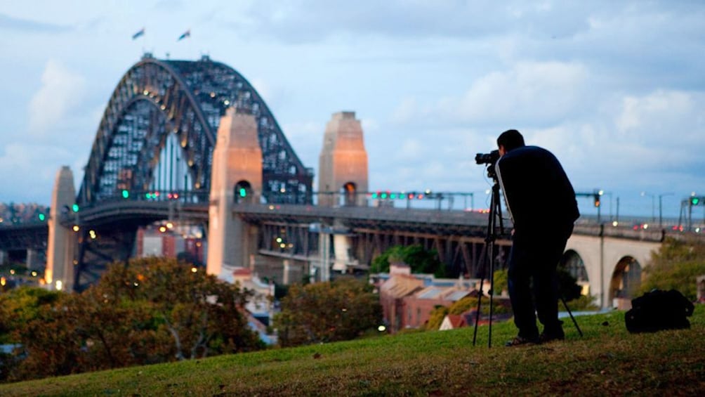 Man photographing the bridge around sunset for Into to Digital Photography workshop in Sydney. 