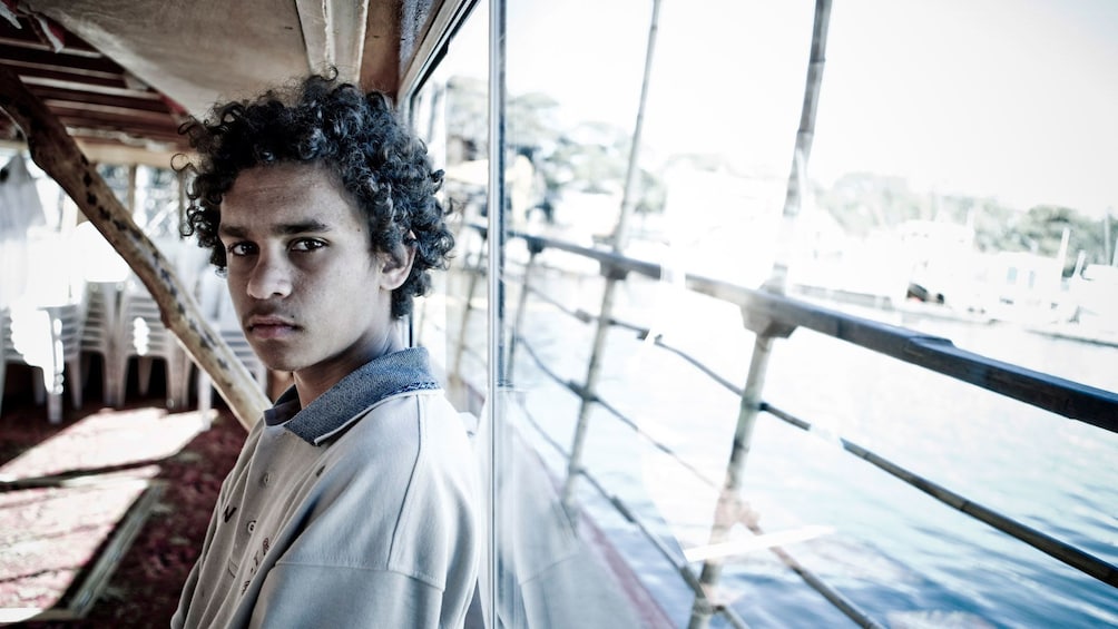 Teenage boy on the deck of a boat in Sydney harbor