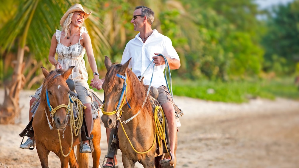 Couple horseback riding on the beach in Saint Lucia