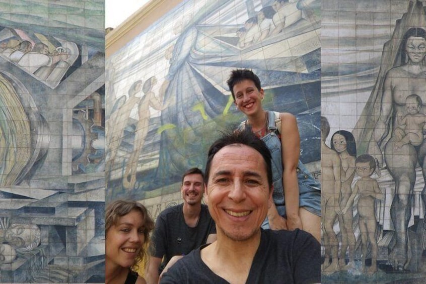 Group of tourists and Rodolfo with mural by Gabriela Mistral.