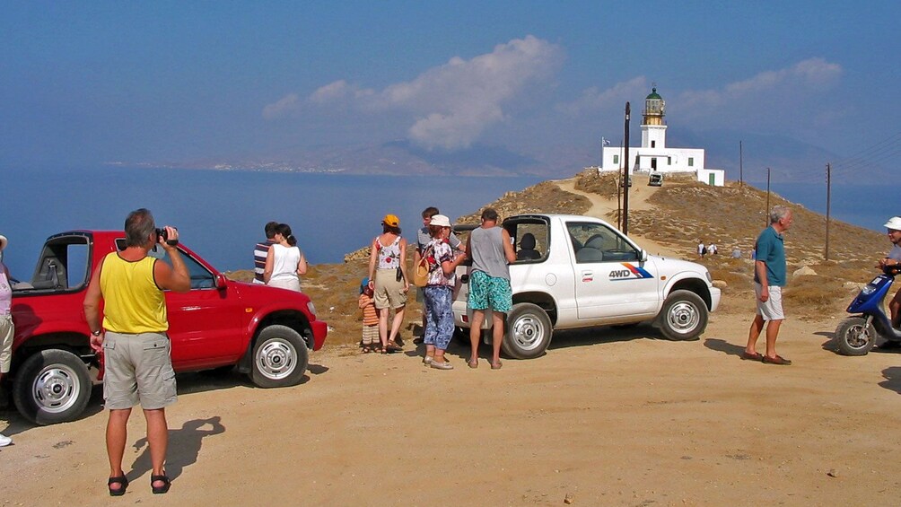 Tour group at a lookout near a lighthouse on Mykonos