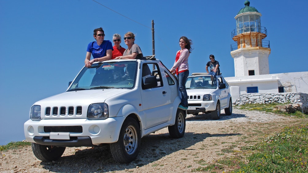 Jeep riding group stopping at a lighthouse on Mykonos