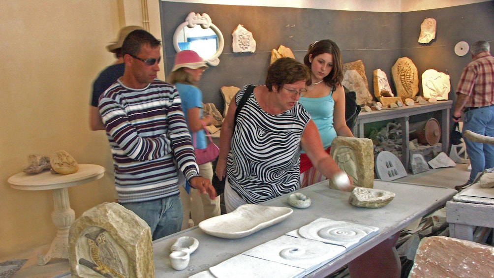 Group looking at handcrafted stone carvings in Tinos