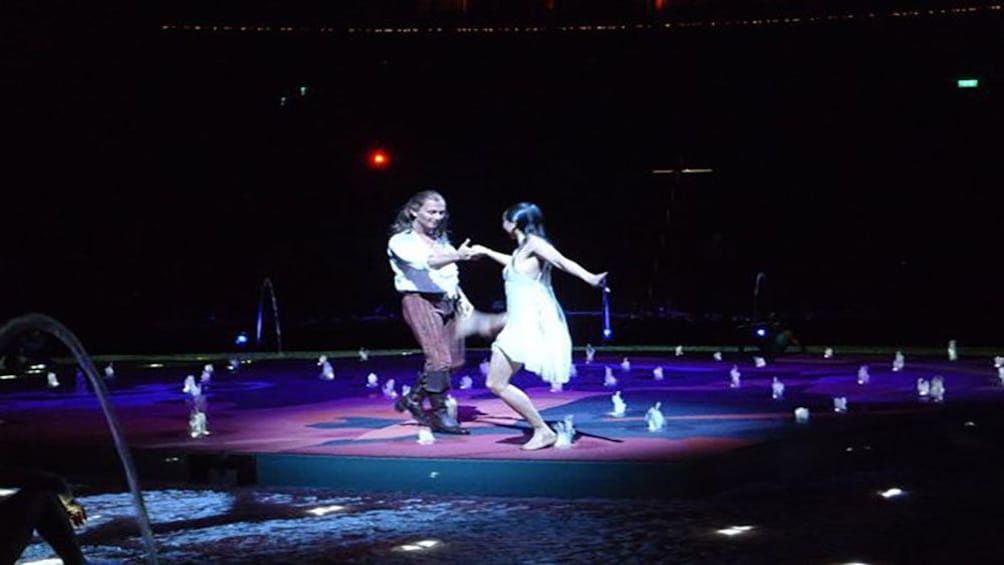 Tampilkan item 5 dari 5. svelte man and woman dancing amidst a circle of water fountains.