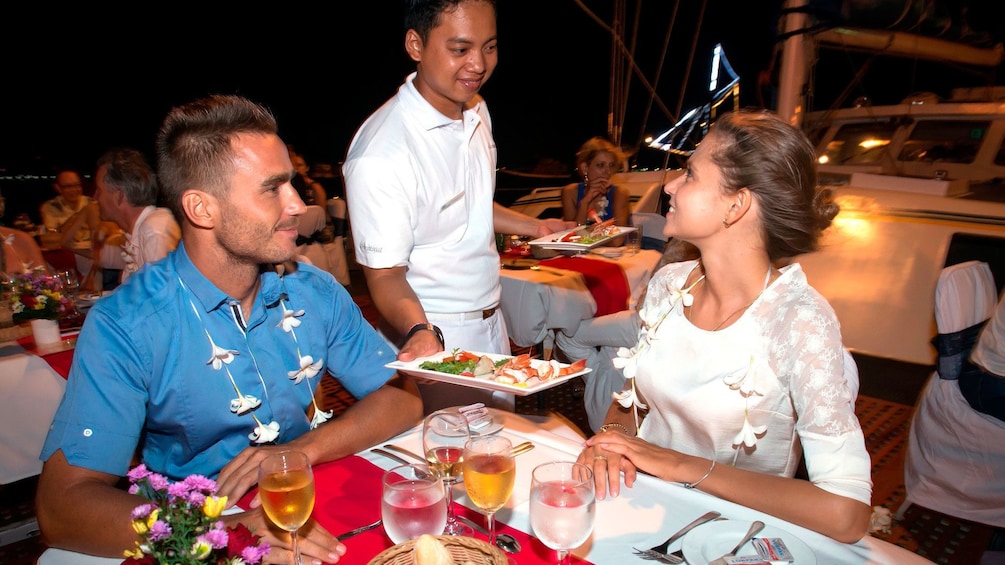 Tampilkan item 2 dari 5. Couple on dinner date at night in Bali Hai