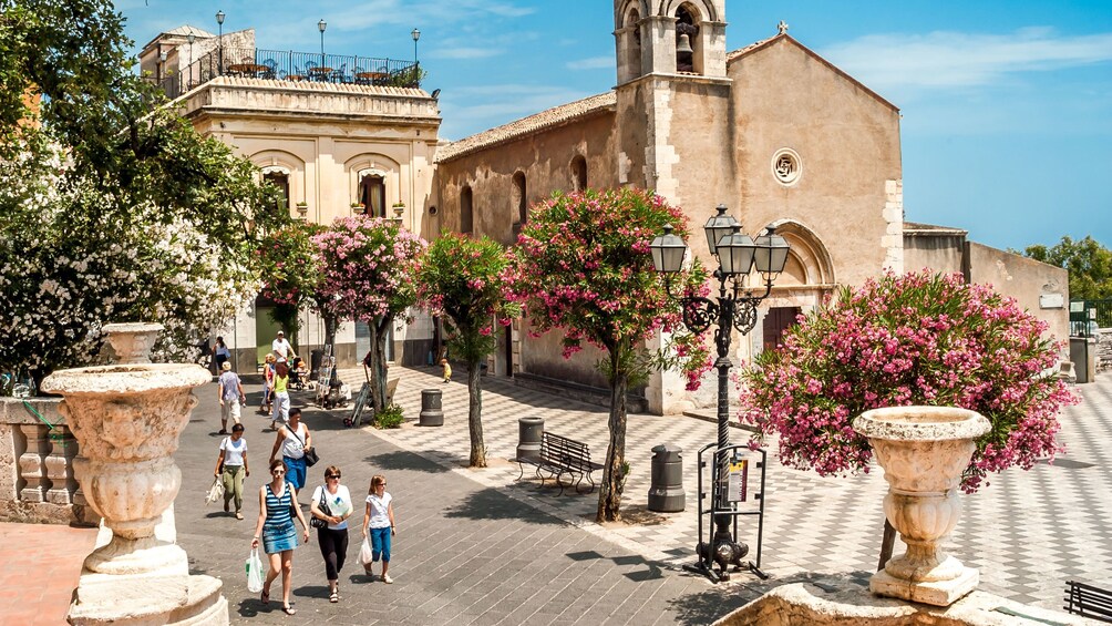 Tourists walking through the city center in Taormina