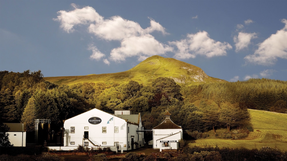 Glengoyne Distillery with green rolling hills in the background in Edinburgh.