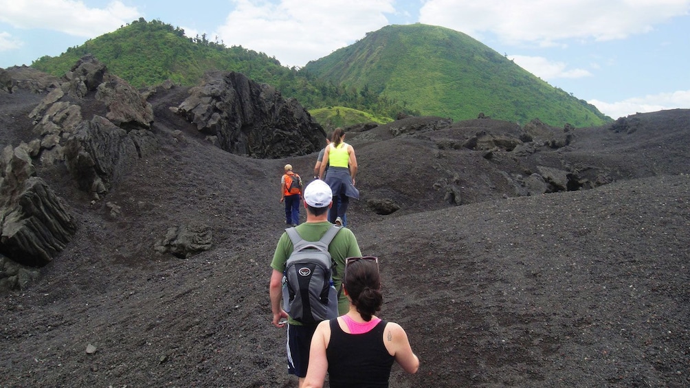 Group hiking through lava rock on Pacaya Volcano