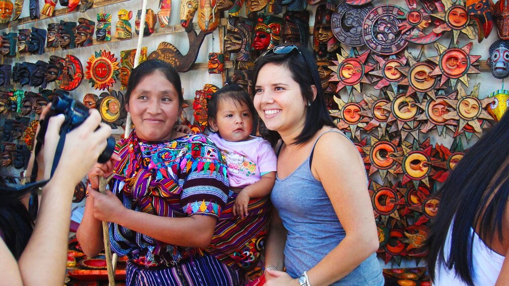Tourist takes photo with local at Chichicastenango market in Guatemala