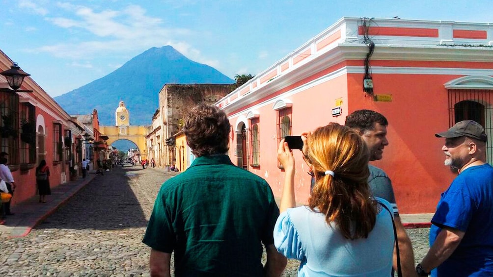 People taking pictures down street of Antigua