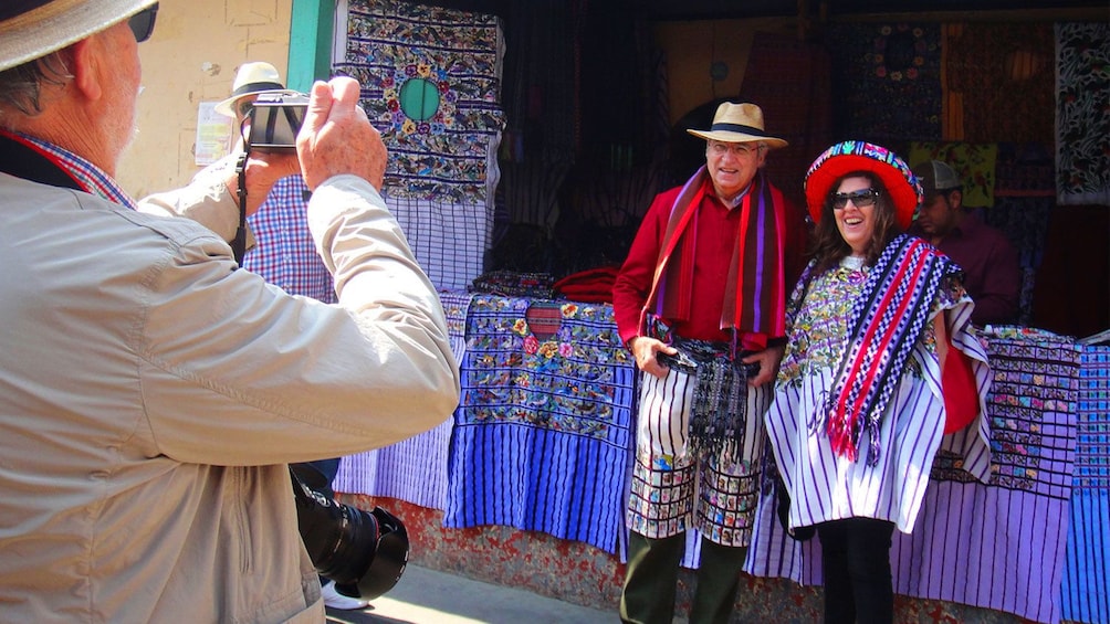 Couple take picture in front of vendor in Santiago