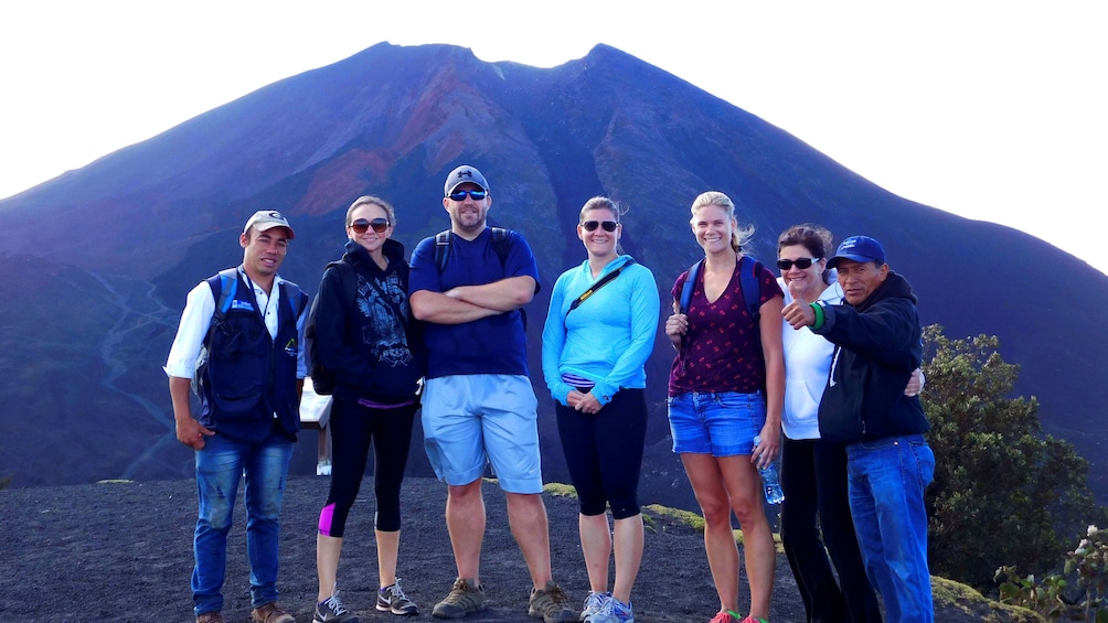 Group takes picture in front of Pacaya Volcano