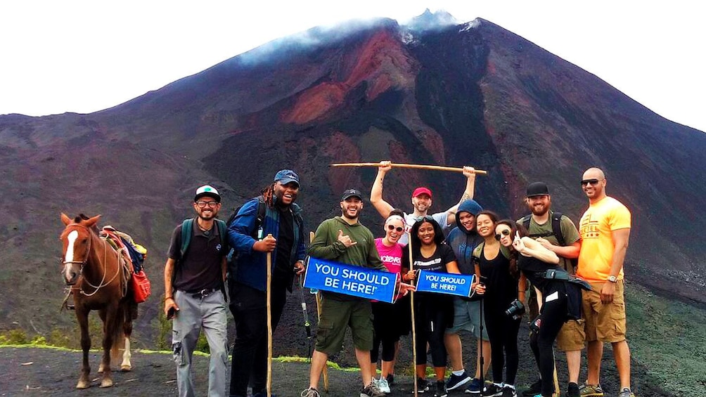 Group stands in front of Pacaya Volcano
