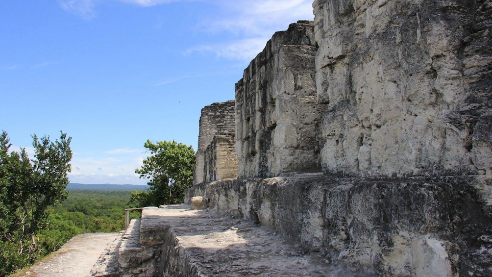 Stone ruins overlooking surrounding forest in Yaxha