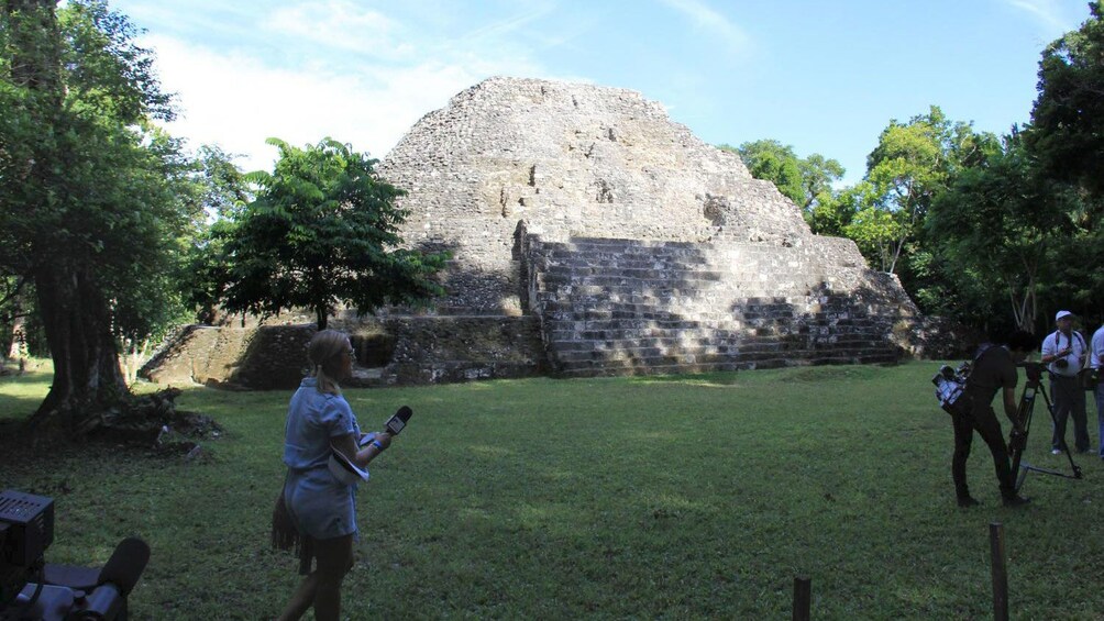 Tour group walking among the ruins at Yaxha