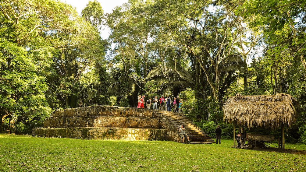 Group standing on ruins in Ceibal