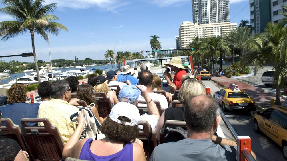 Shot from back of open air Hop in Hop Off bus showing Downtown Miami