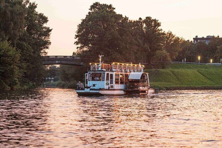 Admire the picturesque bridges of Krakow, stretching across the expanse of the Vistula River. The city's historic and modern bridges are seen in the background.