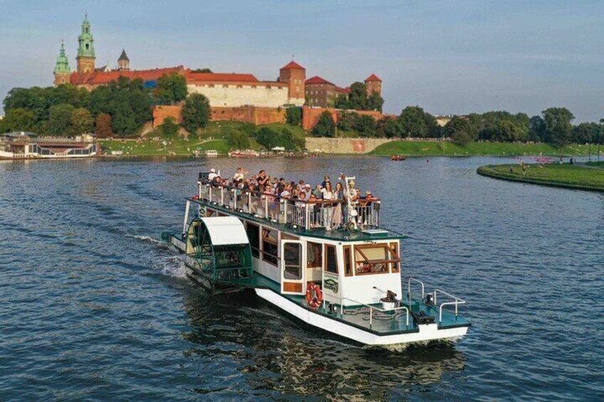 Sightseeing cruise in Krakow by the Legenda boat,- Wawel Castle in the background.