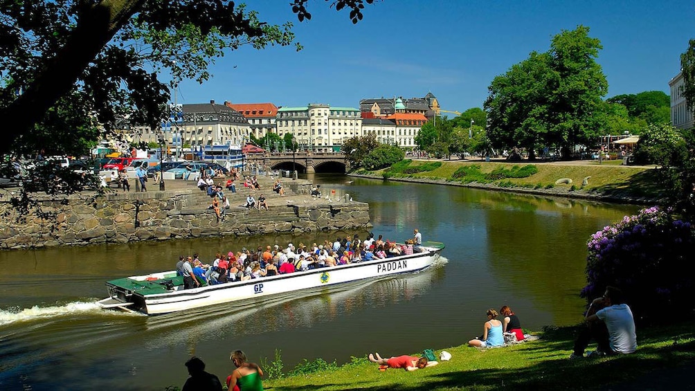 Åpne bilde 5 av 5. Open-top boat with passengers passing through a canal in Gothenburg