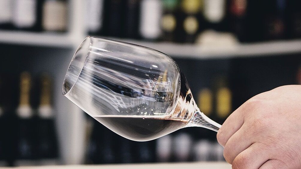 Show item 1 of 7. A person holding a wine glass in San Sebastian