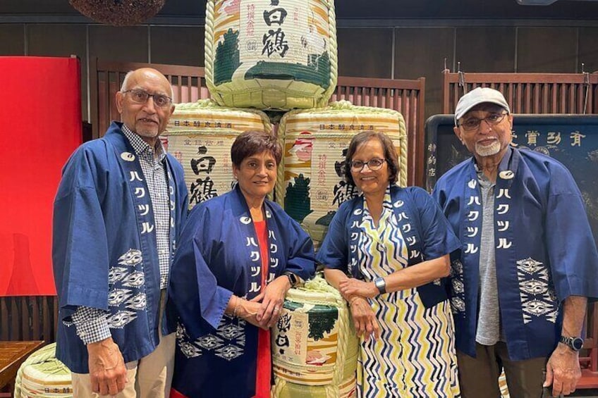 Photo shooting at Hakutsuru Sake brewery wearing traditional happi coats.