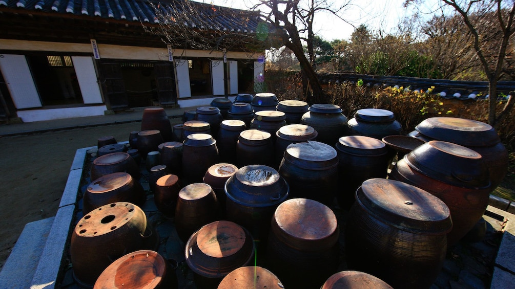 Barrels outside a traditional style building at a Korean Folk Village