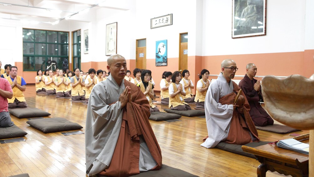 Show item 1 of 5. Praying at a Buddhist temple in Seoul
