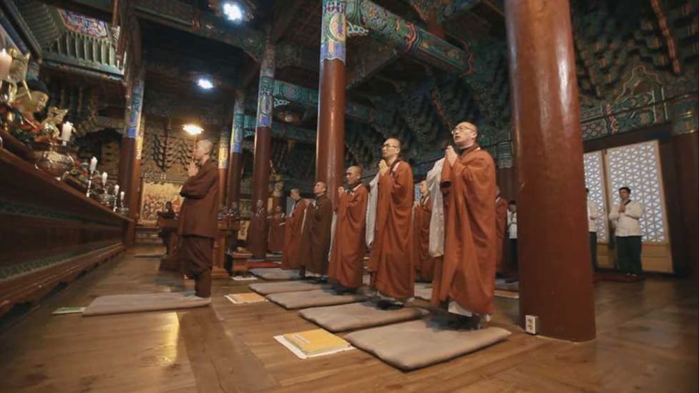Show item 2 of 5. Monlk praying in a Buddhist temple in Seoul