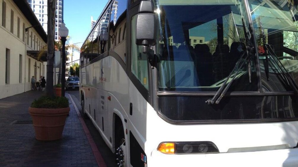 A tour bus parked on a street in Ensenada