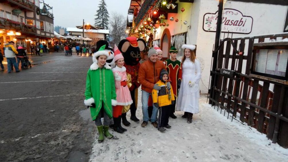 Family in holiday outfits pose in snowy city of Leavenworth