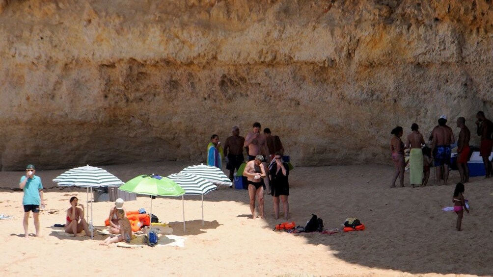 Beachgoers relaxing on the sand on the coast of Algarve